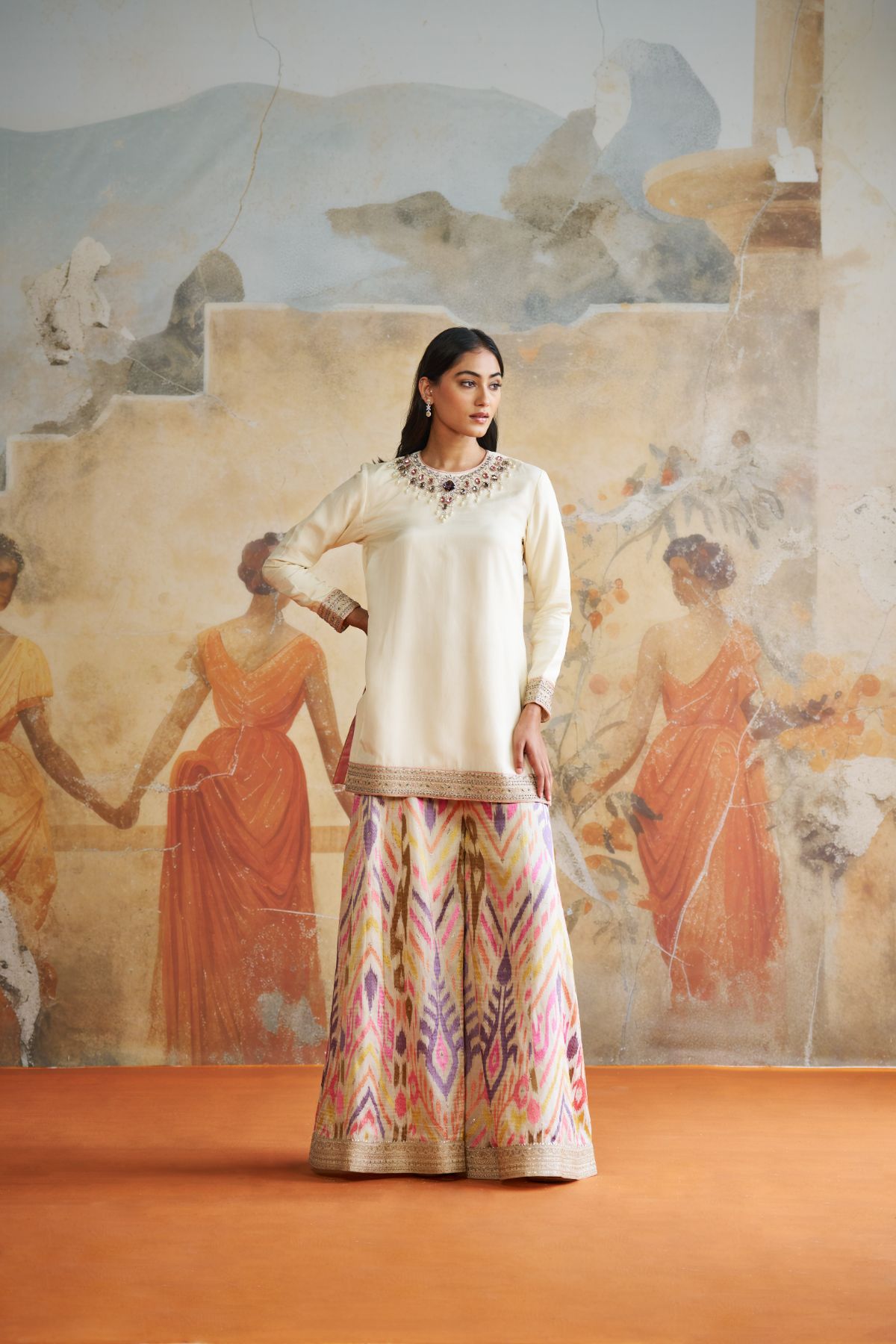 Jeweled short kurta set in peach stones.