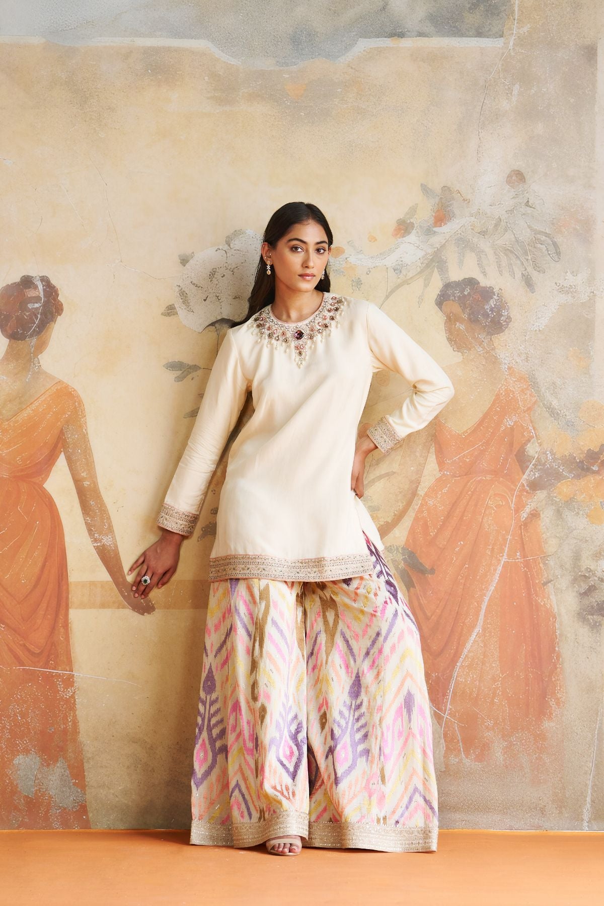 Jeweled short kurta set in peach stones.