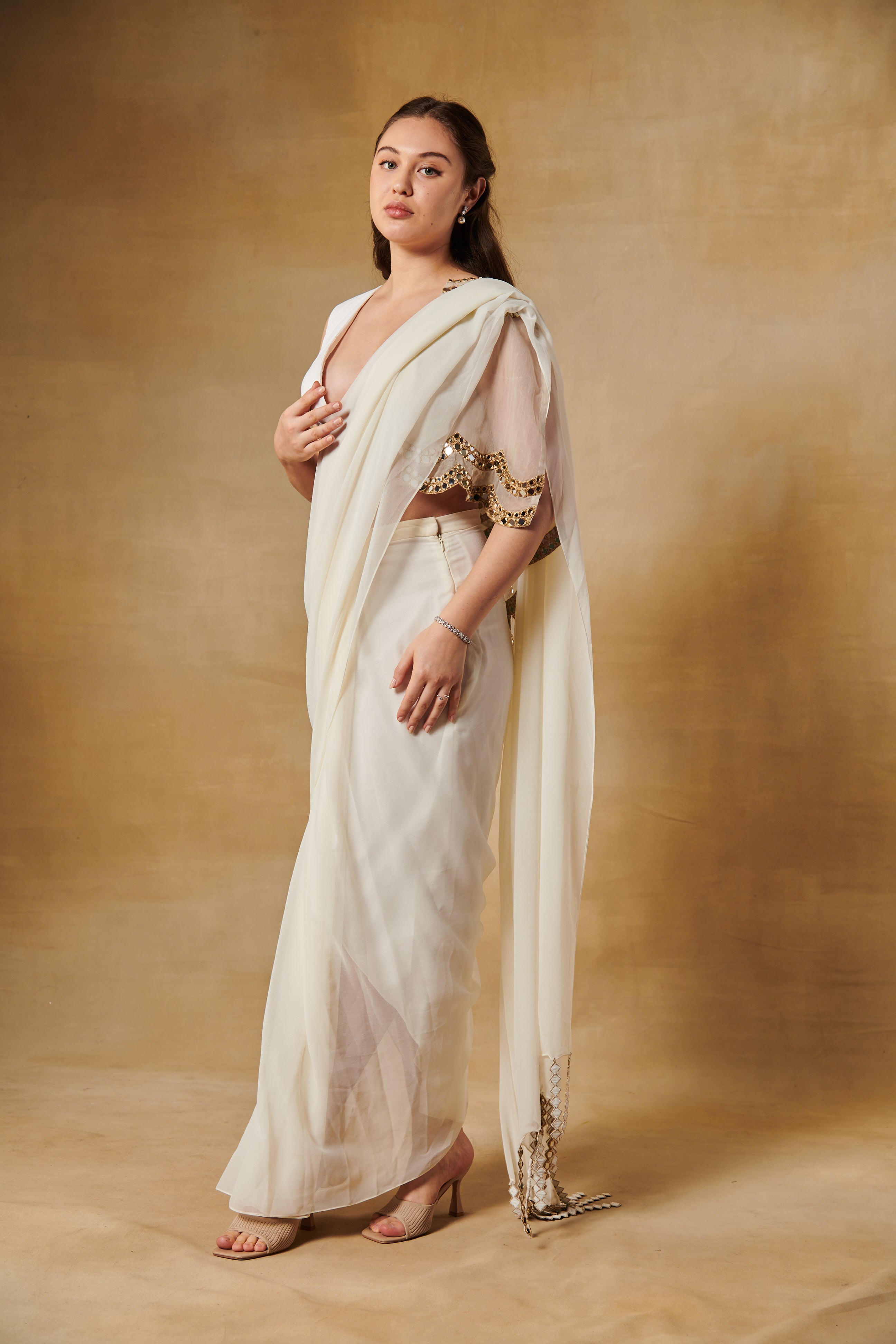 Shell white pre draped saree set layered with mirror work cape.